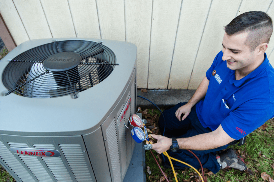 Arctic Air Conditioning employee performing HVAC maintenance