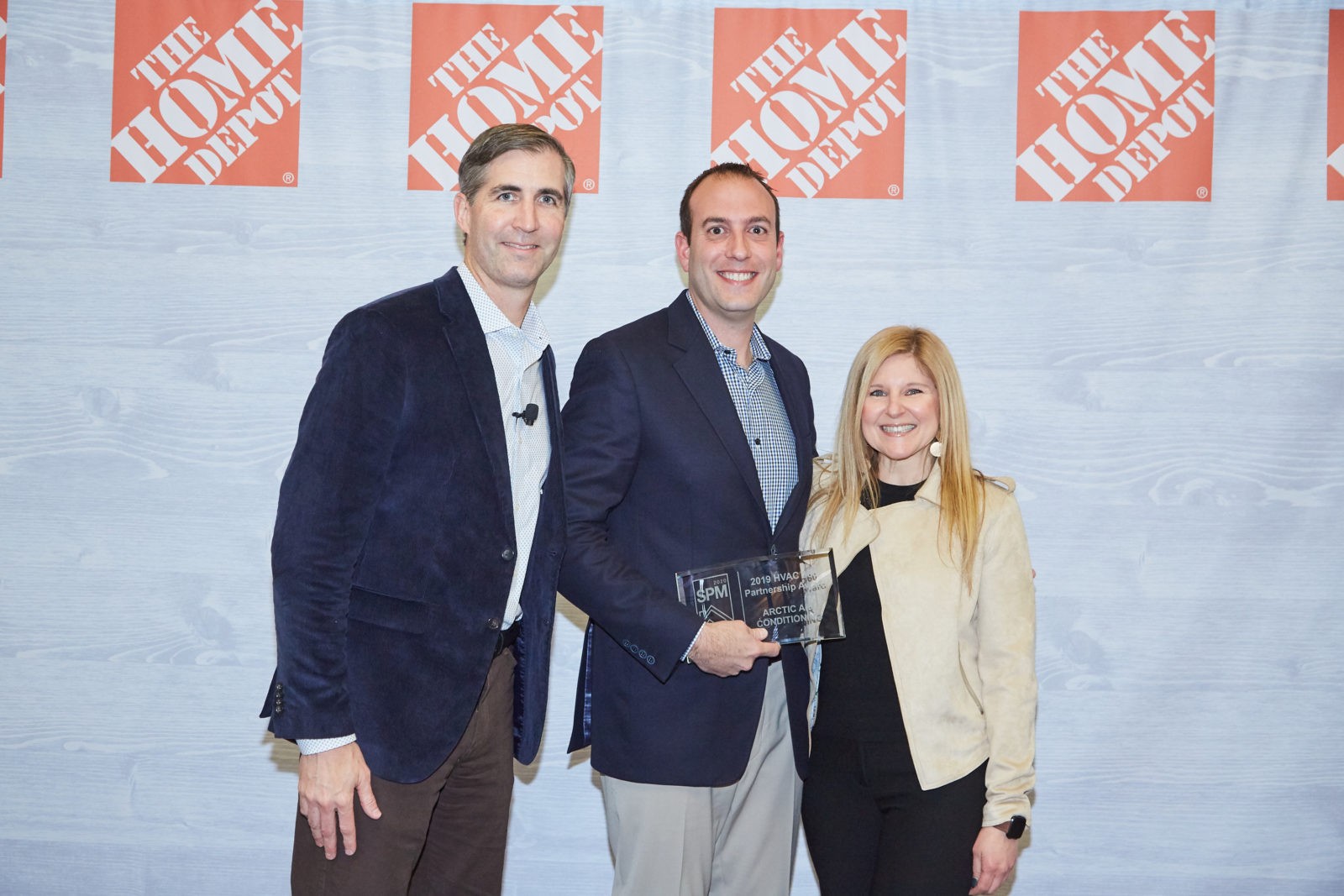 Members of Arctic AC team proudly accepting the 2018 Home Depot HVAC Service Provider of the Year award.