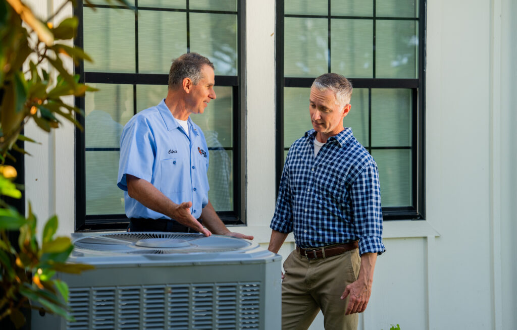 Arctic Air HVAC tech talking with customer