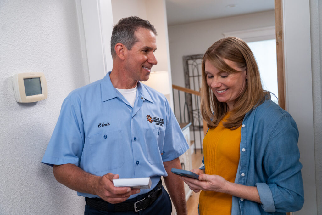 HVAC tech working with client